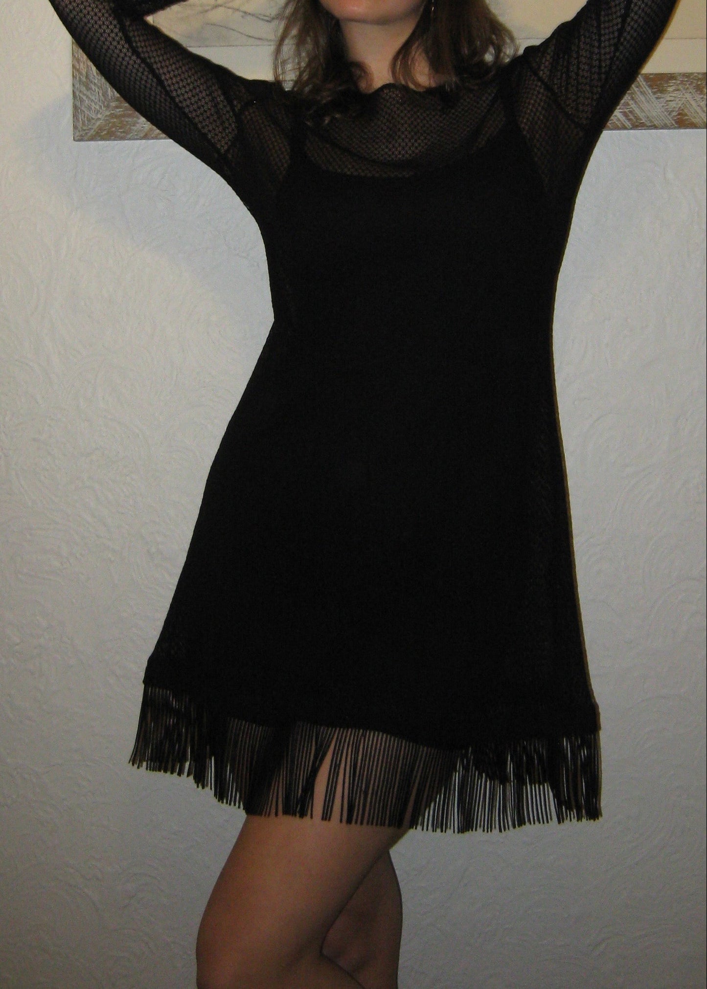 Woman wearing the Kea dress with fringe edge in black Italian micro floral lace facing the front showing fringe movement. Made in Australia.