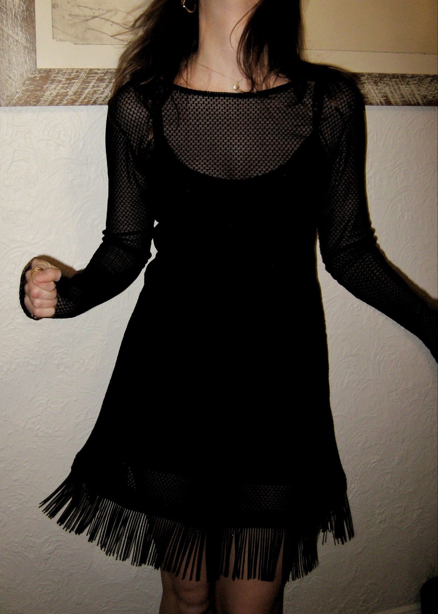 Woman wearing the Kea micro mini dress with fringe edge in black Italian micro floral lace facing forward and showing fringe movement. Made in Australia.