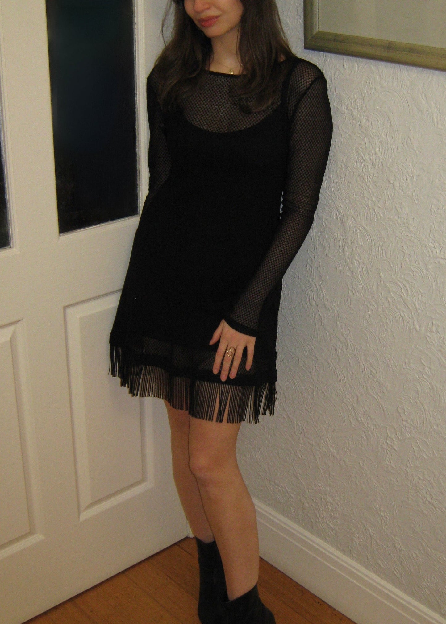 Woman wearing the Kea micro mini dress with fringe edge in black Italian micro floral lace showing lace detail. Made in Australia.