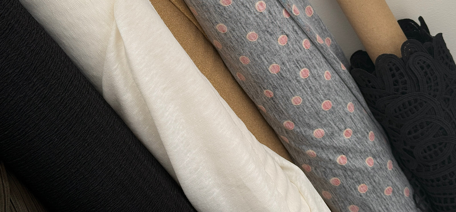 Close up of rolls of fabric, Italian and Japanese, and deadstock