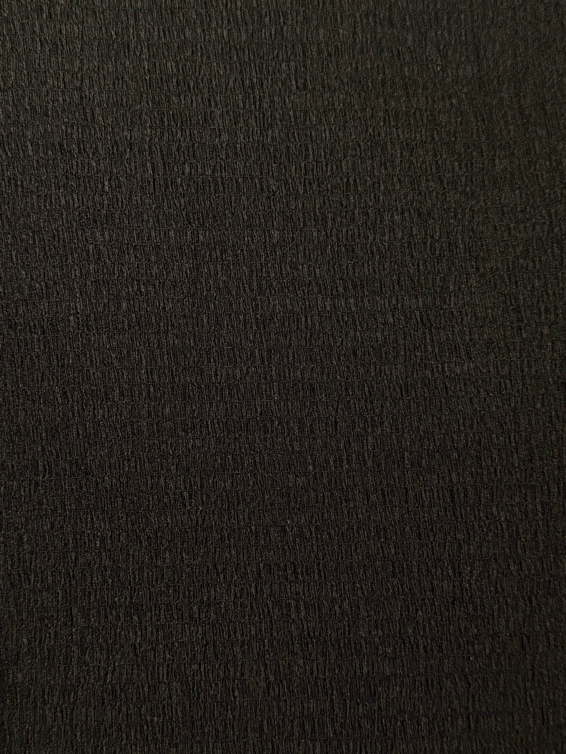 Close up of black crinkle shirred texture. 